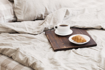 coffee on  tray on the bed in bedroom