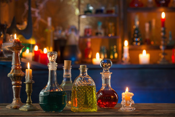 magic potions in bottles on wooden background