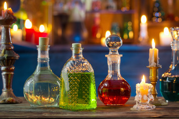 magic potions in bottles on wooden background