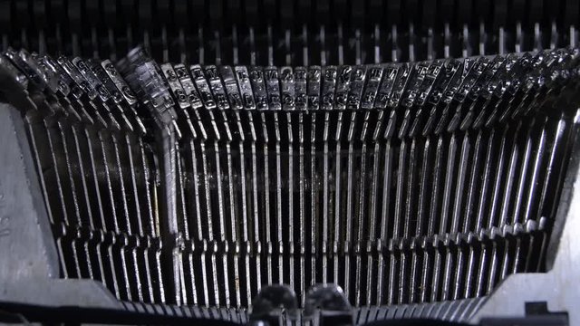 Keys hitting the paper while typing in an old typewriter
