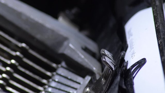 Keys hitting the paper while typing in an old qwerty typewriter