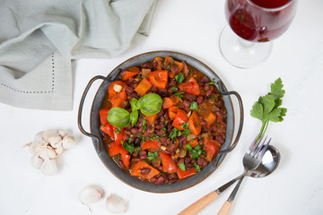 Healthy vegetarian meal of steamed vegetables. Red beans, paprika, tomatoes and greens stewed in tomato sauce. Traditional Caucasian dish - lobio.