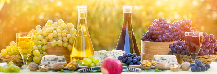 Red and white wine and grape, rich autumn harvest on table in beautiful autumn and of day 