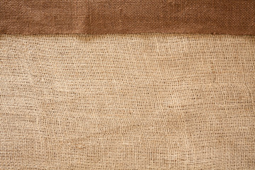 Woven brown horizontal fabric background flat lay from above