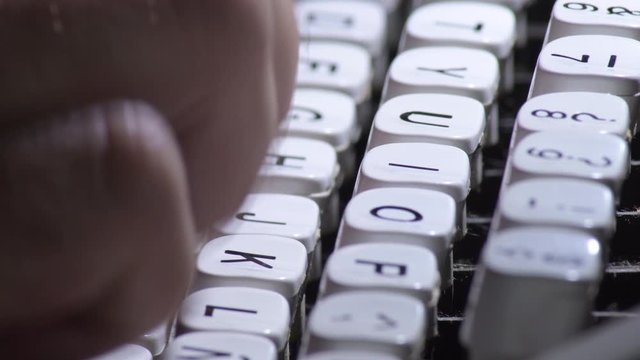Typing in a old qwerty typewriter with white keys