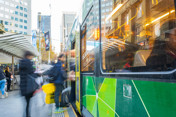 Commuters rushing to board public transport in city street