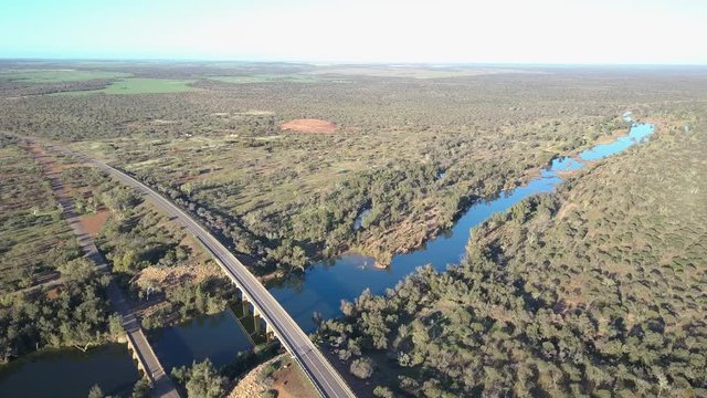 Flight Above Murchison River Towards Kalbarri National Park, With Aerial Panorama Of Outback Country, Highway Bridge And Traffic, Blue Sky And Horizon On A Summer Sunny Day.