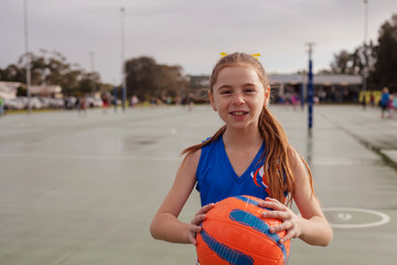 Netball girl holding ball in pre game