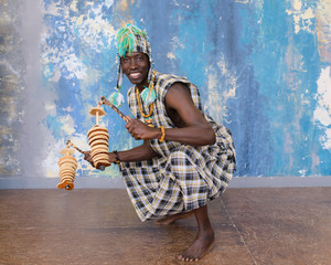 African musician with traditional clothes and musical instruments