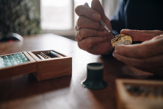 Close-up of senior man repairing a watch