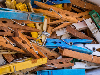 Pile of old plastic and wooden clothes pegs