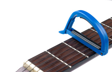 Fototapeta na wymiar Blue guitar capo and guitar isolated on white background.