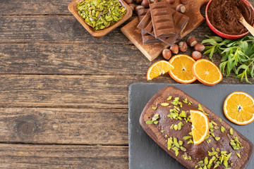 Cake with chocolate , cocoa , flour and hazelnut on the wooden table