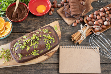Cake with chocolate , cocoa , flour and hazelnut on the wooden table