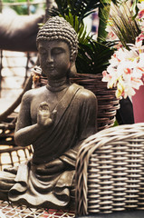 Buddha figure in the garden among the flowers