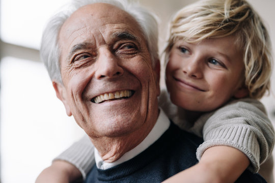 Happy grandson hugging grandfather