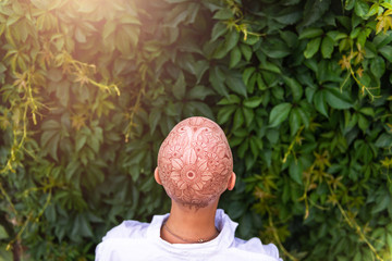Henna mehndi tattoo on womans bald head