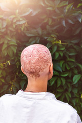 Henna mehndi tattoo on womans bald head