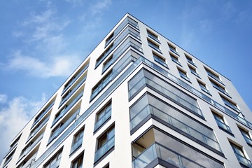 Fototapeta premium Modern and new apartment building. Multistoried modern, new and stylish living block of flats.