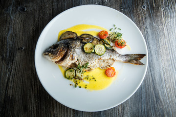 top view on delicious fish served with sliced vegetables