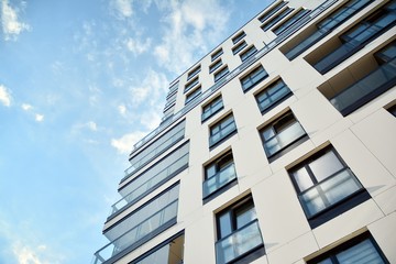 Fototapeta premium Modern and new apartment building. Multistoried modern, new and stylish living block of flats.