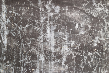 Old dirty peeling painted black metal surface as background