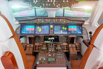 Inside of flight simulator cockpit - dashboard, autopilot, engine management. Runway view.