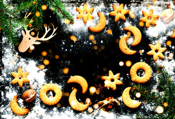 Christmas background. Festive cookies on black background. Blurred  effect