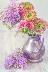Beautiful bouquet of spring flowers in a vase on the table. Lovely bunch of flowers .