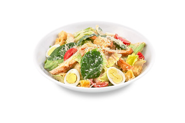 Tasty appetizing fresh salad Caesar with chicken, tomatoes, the eggand cheese parmesan in bowl on white background. View from above.