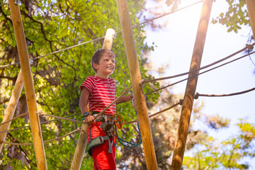 Adventure park exercise happy boy portrait from bellow