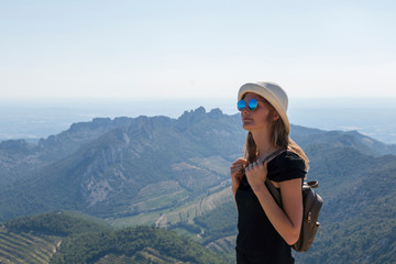 Portrait of active blond caucasian girl at Dentelles de Montmirail chain of mountains in Provence in Vaucluse, France