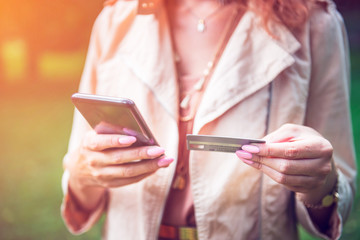 Woman is using mobile smartphone and credit card