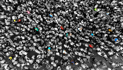Special people amid the crowd concept with colorful persons amid the monochrome people. Top view...
