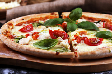vegetarian italian Pizza with tomatoes, mozzarella cheese  and basil. Delicious italian pizza