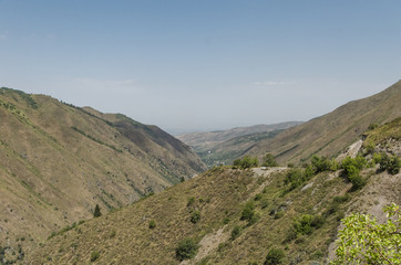 A mountain gorge in which a mountain river flows and a road passes. Location near Almaty, Kazakhstan
