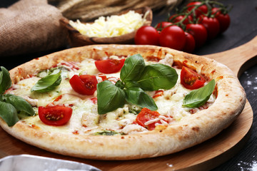 vegetarian italian Pizza with tomatoes, mozzarella cheese  and basil. Delicious italian pizza