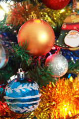 Christmas decorative toys balls on a green tree for the New Year holiday