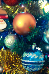 Christmas decorative toys balls on a green tree for the New Year holiday