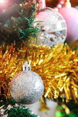 Christmas decorative toys balls on a green tree for the New Year holiday