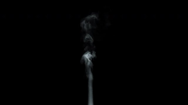 A stream of thick white smoke or steam. White smoke rises from a large pot, which is located behind the frame. Isolated seamless loop black background.