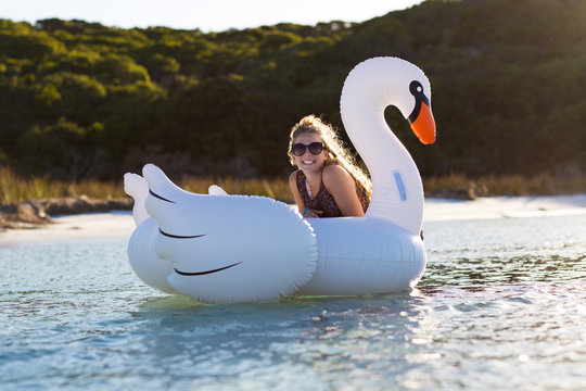Portrait of girl in water with inflatable swan