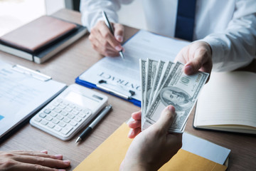 Dishonest cheating in business illegal money, Businessman giving bribe money in business people to accept agreement contract of investment deal, Bribery and corruption concept