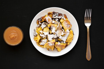 Homemade german Kaiserschmarrn pancake on a black background, top view. Flat lay, overhead, from above.