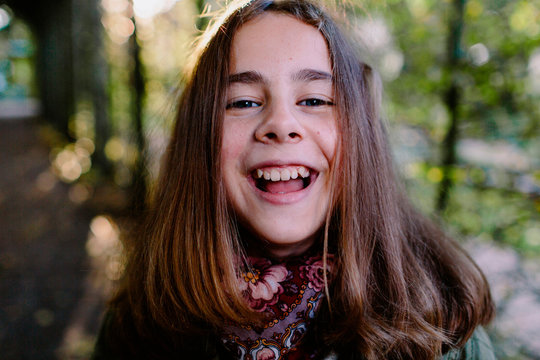 Portrait of laughing young girl in a park