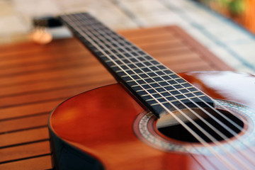 Obraz na płótnie Canvas Music Concept: Brown acoustic guitar on a wooden background.