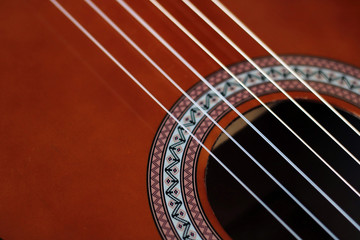 Obraz premium Music Concept: Brown acoustic guitar on a wooden background.