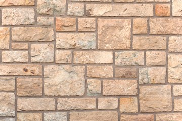 Square stones on a rustic wall. Texture detail.