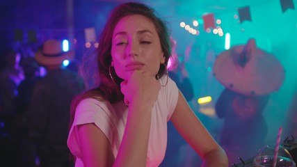 Portait of sad enchanting young woman in fashion look at bar counter looking around being lonely at youth night party in the club.