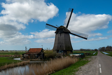 Dutch windmill with a blue sky as background
